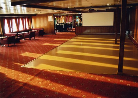 Further aft, the aftmost port-side lounge is now rather sparsely furnished, with a big screen which is used to show football matches.