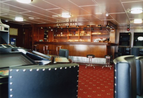 One of the two aft port lounges has had casino and gaming equipment installed, but it still retains its original bar counter.