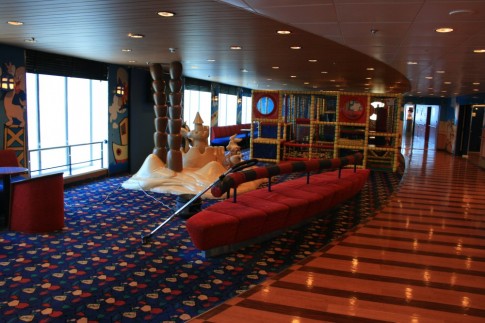 To starboard is a lengthy open-plan space stretching forward with a variety of facilities laid out along it. At the aft end of can be found the childrens' play area - seen here on the relatively Looney Tunes free Moby Freedom.
