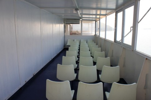 In a bid to increase the ship's passenger capacity, a pair of charming "lounges" were added on former open deck space, just aft of the bridge wings - here is the starboard side version.
