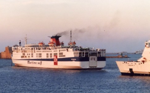 Leaving for Patras is Maritime Way's Erotokritos, a Japanese-built Greek veteran which saw many years of service with Minoan Lines. Between her stern and the bow of the Penelope A can be seen the distant shapes of the laid up Jupiter (ex-Surrey) and Tirana (ex-Linda Scarlett).