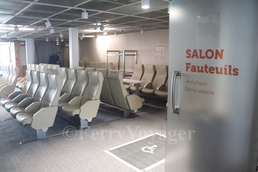 The smaller central shop created by Stena now serves as a reclining seat lounge; surrounded by glass bulkheads to previously entice shoppers in, curtains are now in place to ensure privacy at night.