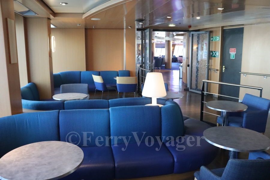 Moving astern, there are two smaller side lounges on either beam - these remained open to the public in her Stena era, although the glass doors separating the forward Stena Plus lounge can still be seen in the distance.