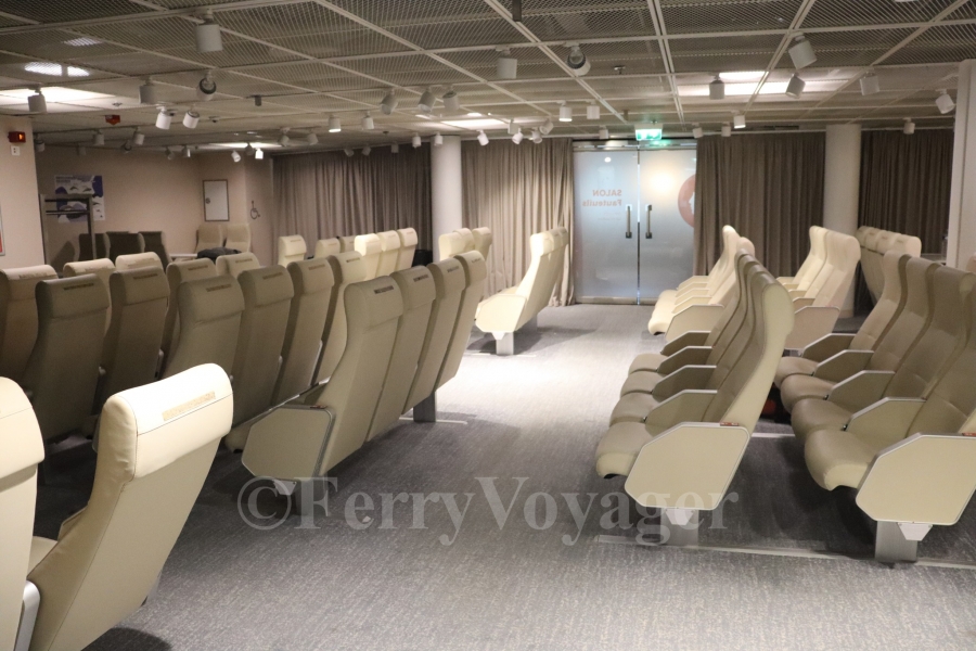 The smaller central shop created by Stena now serves as a reclining seat lounge; surrounded by glass bulkheads to previously entice shoppers in, curtains are now in place to ensure privacy at night.