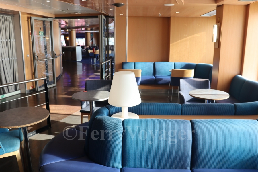 Moving astern, there are two smaller side lounges on either beam - these remained open to the public in her Stena era, although the glass doors separating the forward Stena Plus lounge can still be seen in the distance.